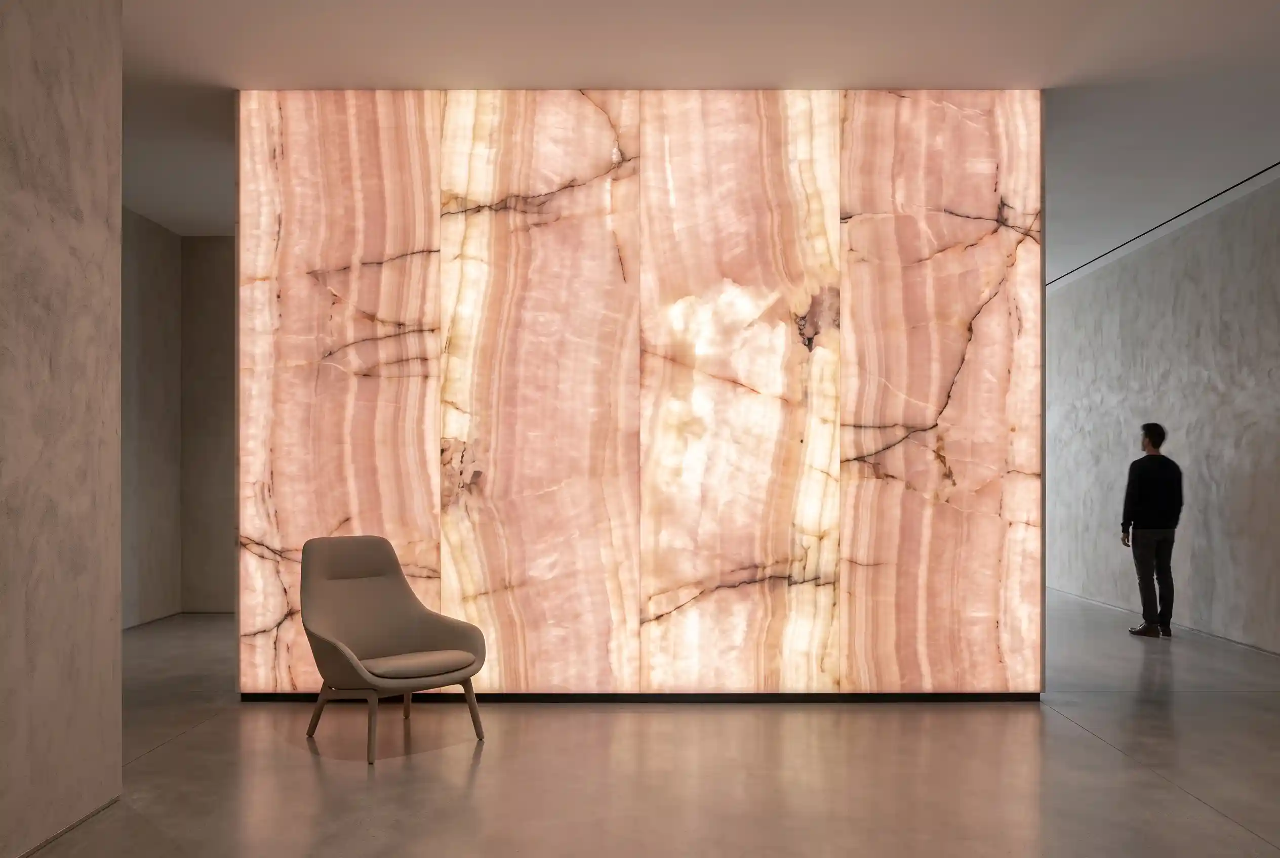 Backlit pink onyx architectural panel revealing natural banding and vein variation Backlit pink onyx architectural panel revealing natural banding and vein variation